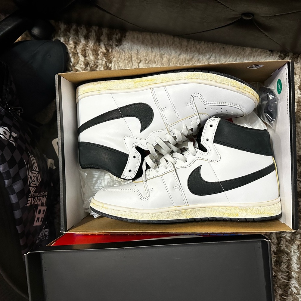 A Ma Maniere Air Ship Nike White and Black Athletic Shoes with High-Top Design